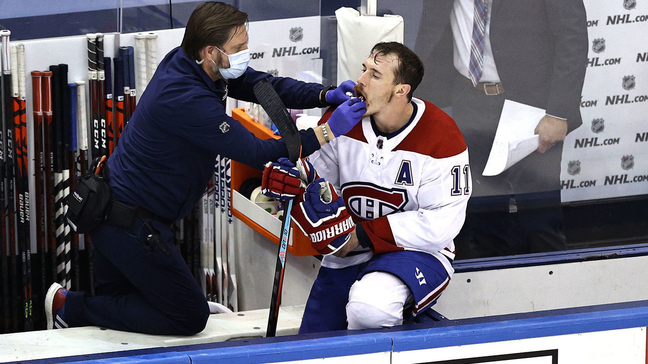TORONTO, ONTARIO - AUGUST 19: Brendan Gallagher #11 of the Montreal Canadiens is treated by the trainer after sustaining an injury against the Philadelphia Flyers during the third period in Game Five of the Eastern Conference First Round during the 2020 NHL Stanley Cup Playoffs at Scotiabank Arena on August 19, 2020 in Toronto, Ontario.