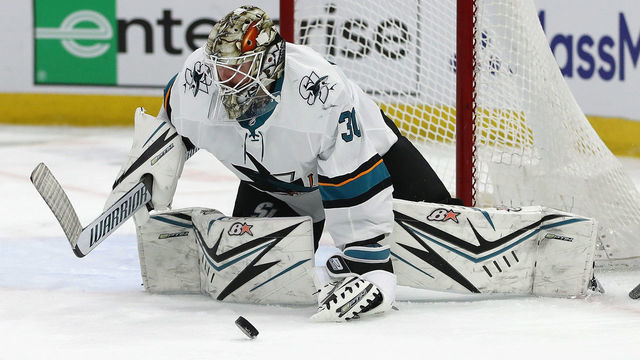 CHICAGO, ILLINOIS - MARCH 11: Aaron Dell #30 of the San Jose Sharks drops to make a save against the Chicago Blackhawks at the United Center on March 11, 2020 in Chicago, Illinois.