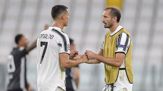 TURIN, ITALY - AUGUST 07: Cristiano Ronaldo of Juventus disappointed hugs his teammate Giorgio Chiellini after the UEFA Champions League round of 16 second leg match between Juventus and Olympique Lyon at Allianz Stadium on August 07, 2020 in Turin, Italy.