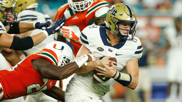MIAMI GARDENS, FL - NOVEMBER 24: Kenny Pickett #8 of the Pittsburgh Panthers is sacked by Michael Jackson #28 of the Miami Hurricanes during the second half at Hard Rock Stadium on November 24, 2018 in Miami Gardens, Florida.