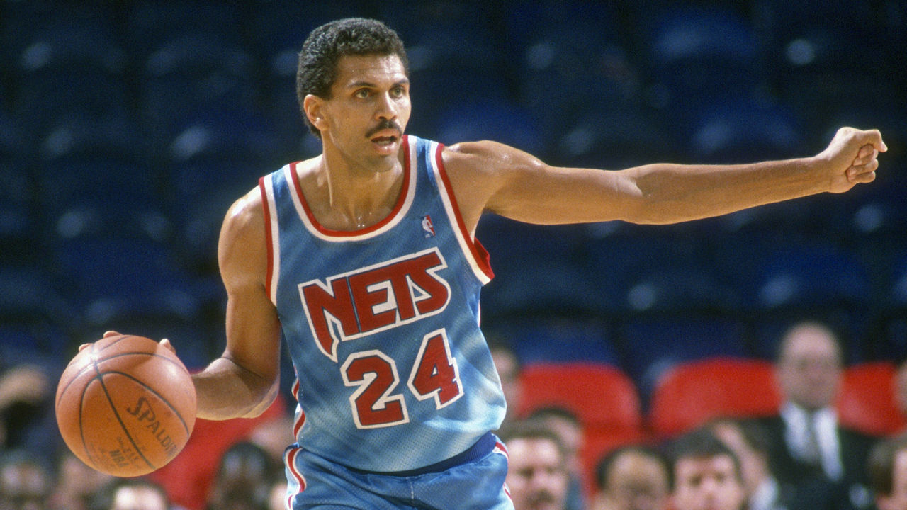 LANDOVER, MD - CIRCA 1991: Reggie Theus #24 of the New Jersey Nets dribbles the ball up court and calls out a play against the Washington Bullets during an NBA basketball game circa 1991 at the Capital Centre in Landover, Maryland. Theus played for the Nets from 1990-91.