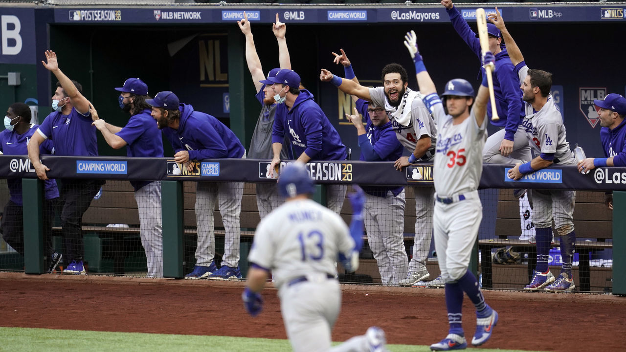 ARLINGTON, TX - OCTOBER 14: The Dodgers dugout erupts after Max Muncy #13 of the Los Angeles Dodgers hits a grand slam in the first inning during Game 3 of the NLCS between the Atlanta Braves and the Los Angeles Dodgers at Globe Life Field on Wednesday, October 14, 2020 in Arlington, Texas.