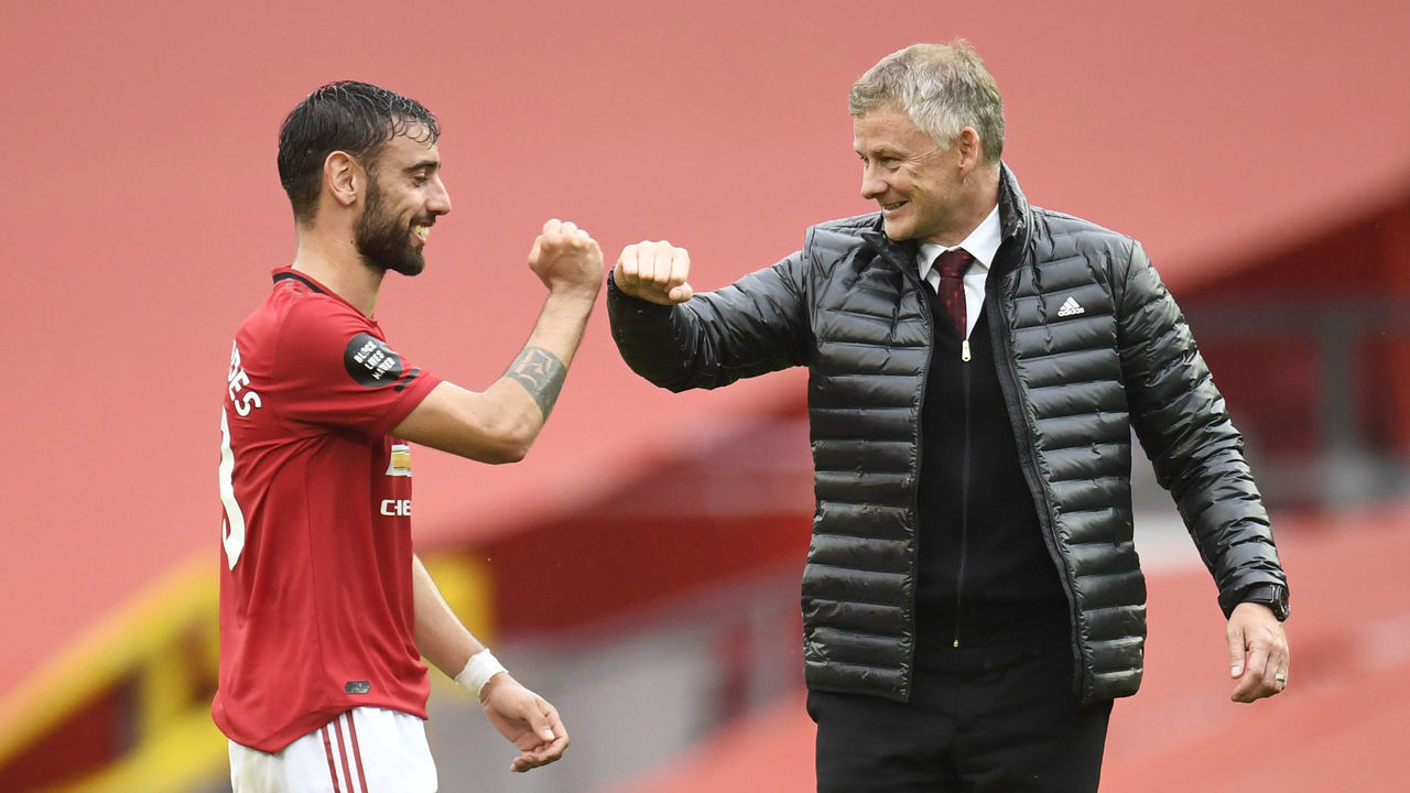 MANCHESTER, ENGLAND - JULY 04: Bruno Fernandes of Manchester United and Ole Gunnar Solskjaer, Manager of Manchester United elbow bump following the Premier League match between Manchester United and AFC Bournemouth at Old Trafford on July 04, 2020 in Manchester, England. Football Stadiums around Europe remain empty due to the Coronavirus Pandemic as Government social distancing laws prohibit fans inside venues resulting in all fixtures being played behind closed doors.