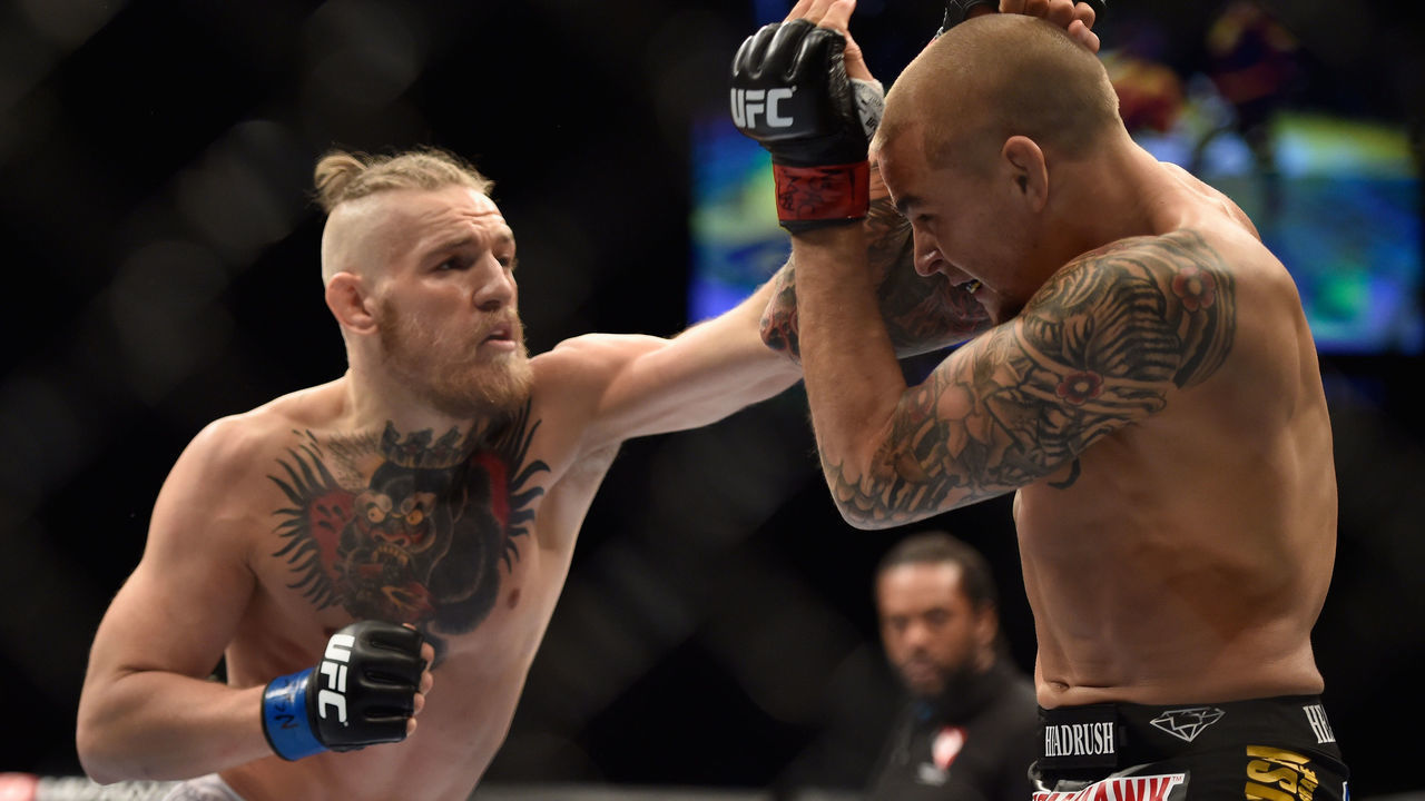 LAS VEGAS, NV - SEPTEMBER 27: (L-R) Conor McGregor punches Dustin Poirier in their featherweight fight during the UFC 178 event inside the MGM Grand Garden Arena on September 27, 2014 in Las Vegas, Nevada.