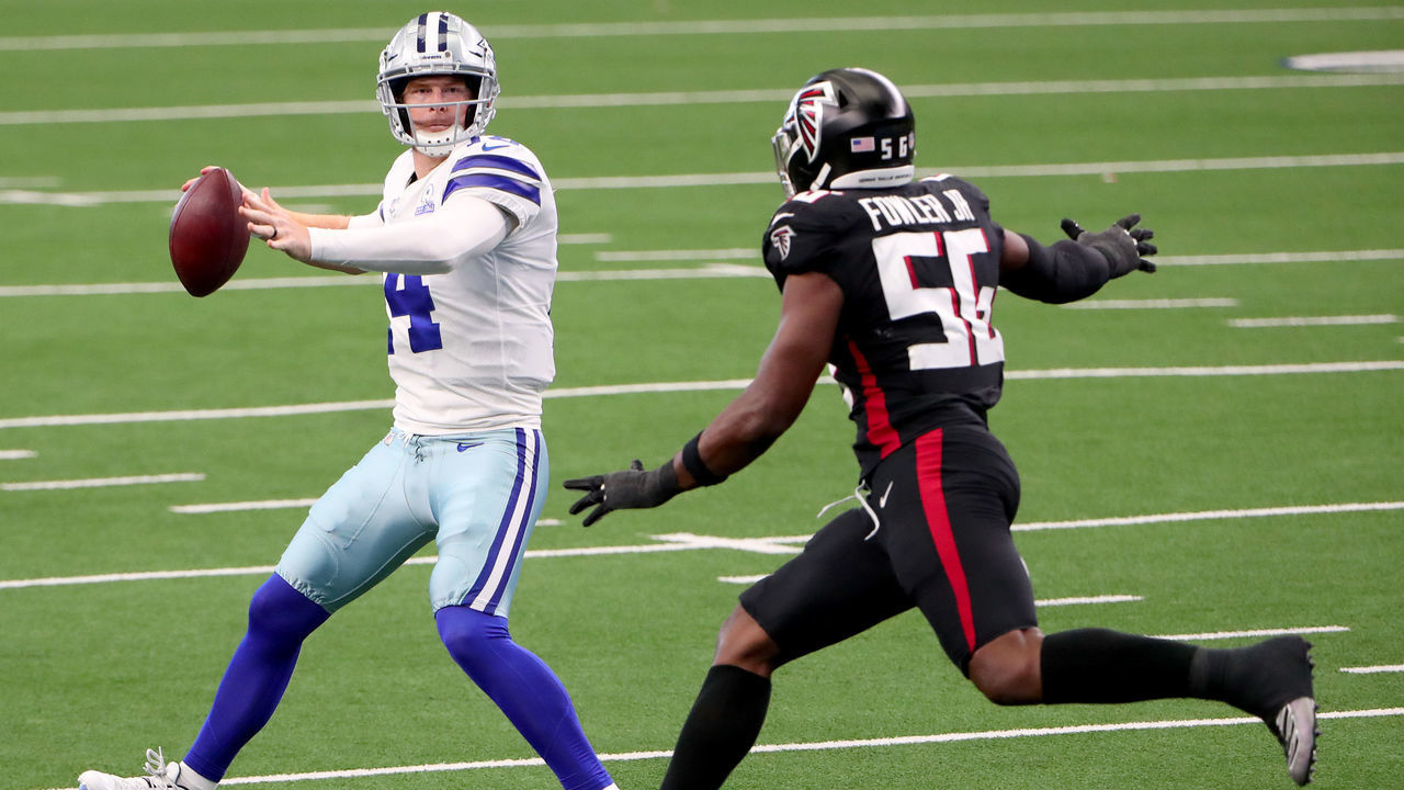 ARLINGTON, TEXAS - SEPTEMBER 20: Andy Dalton #14 of the Dallas Cowboys looks for an open receiver against Dante Fowler Jr. #56 of the Atlanta Falcons in the third quarter at AT&T Stadium on September 20, 2020 in Arlington, Texas.