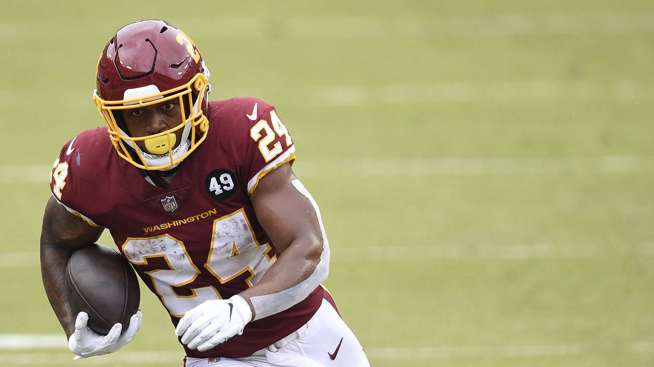 LANDOVER, MARYLAND - OCTOBER 11: Antonio Gibson #24 of the Washington Football Team runs with the ball in the first half against the Los Angeles Rams at FedExField on October 11, 2020 in Landover, Maryland.
