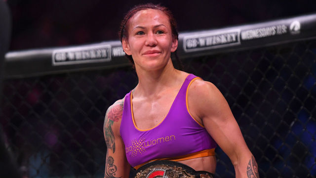 INGLEWOOD, CA - JANUARY 25: Cris Cyborg (blue gloves) in the cage after defeating Julia Budd in their featherweight world title fight at The Forum on January 25, 2020 in Inglewood, California. Cyborg won by TKO in the 4th round.