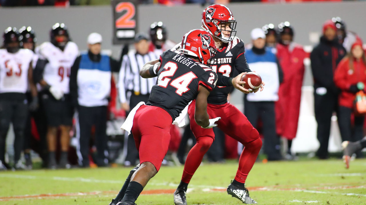 RALEIGH, NC - NOVEMBER 16: North Carolina State Wolfpack quarterback Devin Leary (13) passes the ball to North Carolina State Wolfpack running back Zonovan Knight (24)during the 2nd half of the NC State Wolfpack game versus the Louisville Cardinals on November 16th, 2019 at Carter-Finley Stadium in Raleigh, NC.