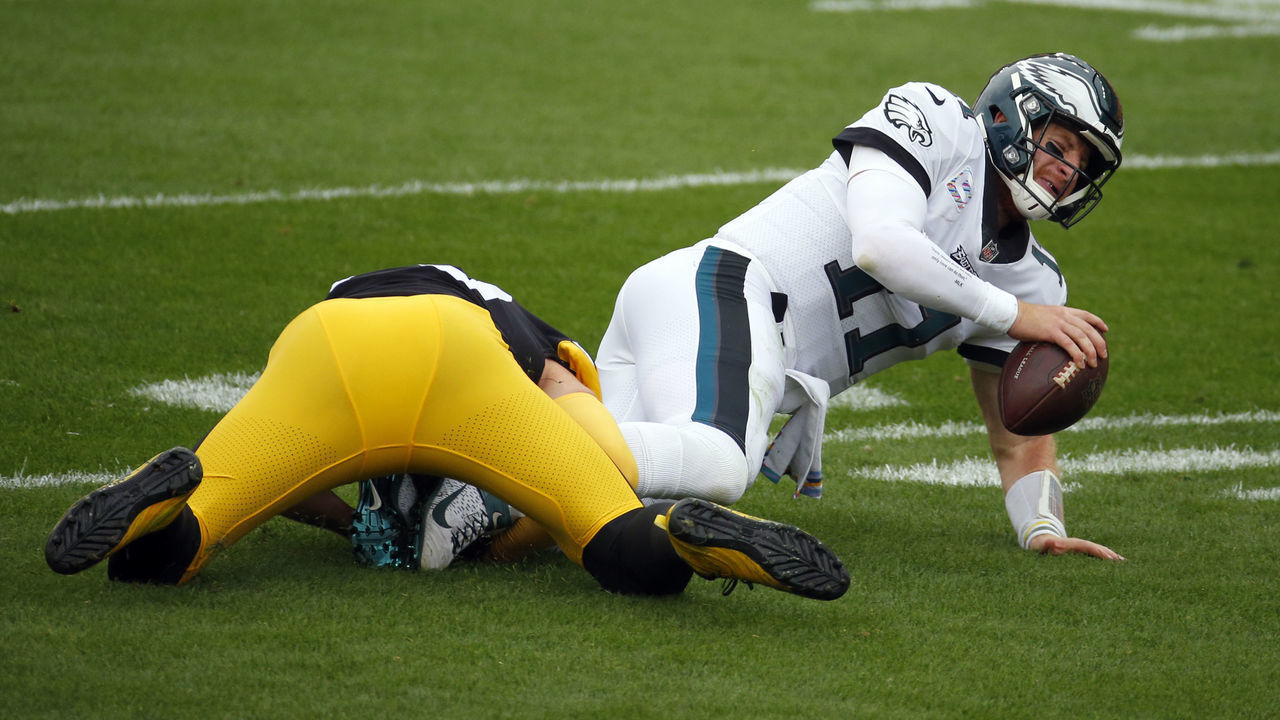 PITTSBURGH, PA - OCTOBER 11: T.J. Watt #90 of the Pittsburgh Steelers sacks Carson Wentz #11 of the Philadelphia Eagles in the first half on October 11, 2020 at Heinz Field in Pittsburgh, Pennsylvania.