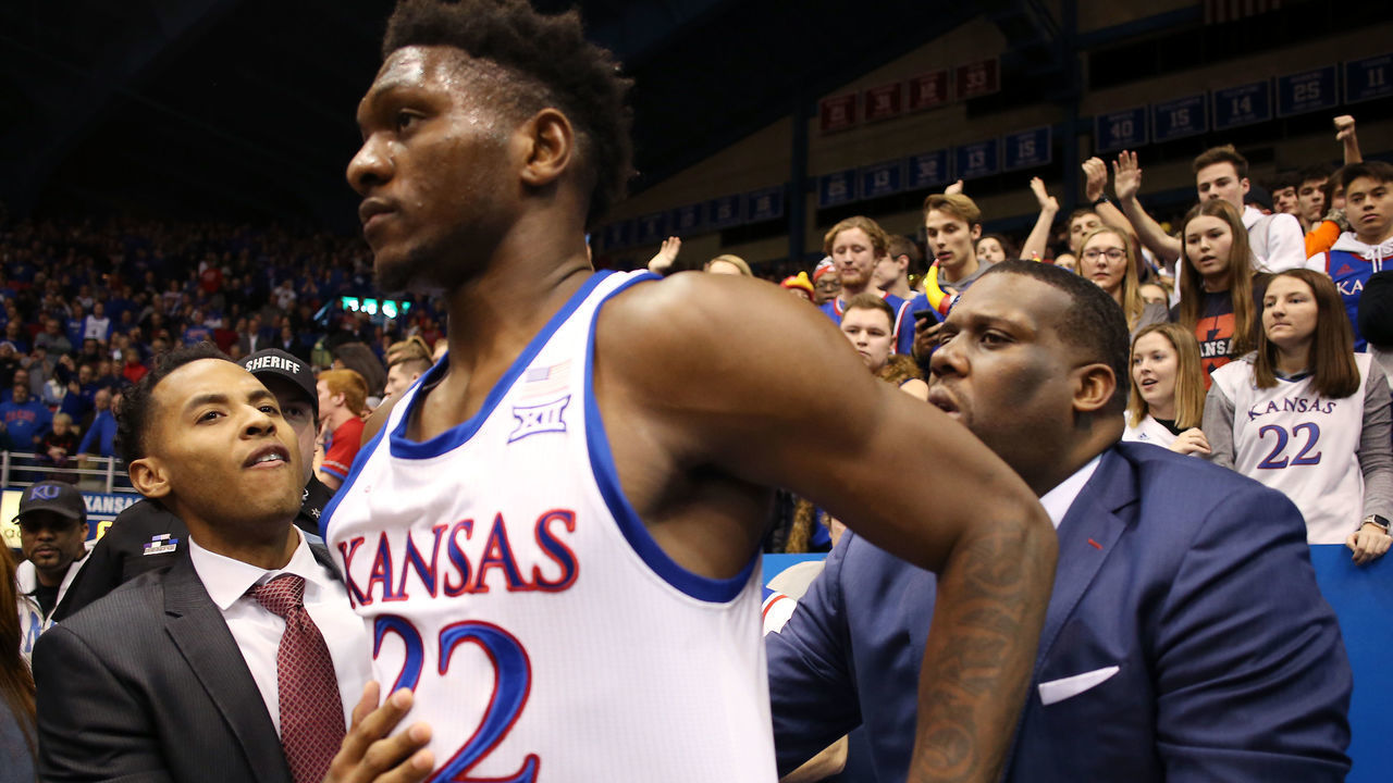 LAWRENCE, KANSAS - JANUARY 21: Silvio De Sousa #22 of the Kansas Jayhawks is restrained by coaches during a brawl as the game against the Kansas State Wildcats ends at Allen Fieldhouse on January 21, 2020 in Lawrence, Kansas.