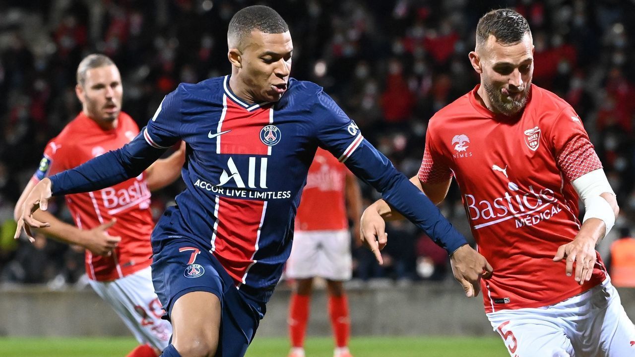 Paris Saint-Germain's French forward Kylian Mbappe (L) vies for the ball with Nimes' French defender Gaetan Paquiez during the French L1 football match between Nimes (NO) and Paris Saint Germain (PSG) at the Costieres Stadium in Nimes, southern France, on October 16, 2020.