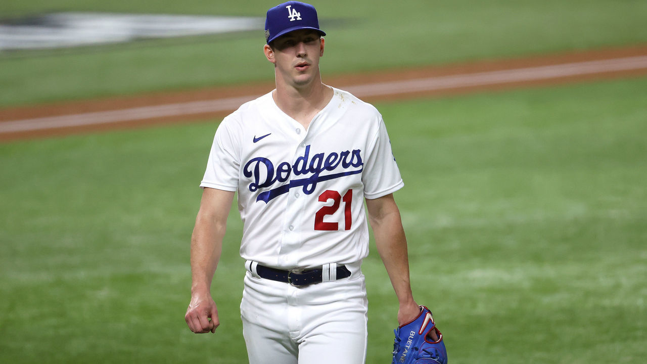 ARLINGTON, TEXAS - OCTOBER 12: Walker Buehler #21 of the Los Angeles Dodgers walks to the dugout after the top of the fourth inning against the Atlanta Braves in Game One of the National League Championship Series at Globe Life Field on October 12, 2020 in Arlington, Texas.