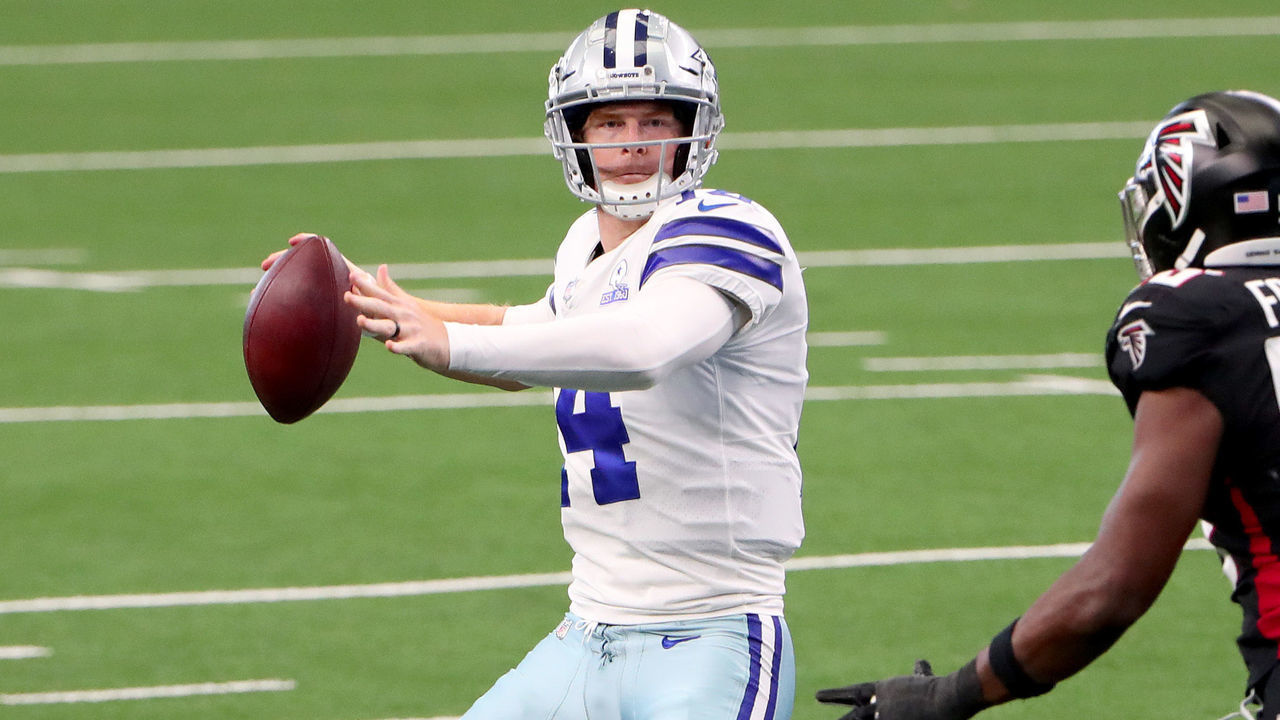 ARLINGTON, TEXAS - SEPTEMBER 20: Andy Dalton #14 of the Dallas Cowboys looks for an open receiver against Dante Fowler Jr. #56 of the Atlanta Falcons in the third quarter at AT&T Stadium on September 20, 2020 in Arlington, Texas.
