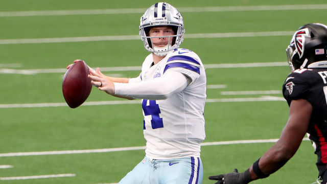ARLINGTON, TEXAS - SEPTEMBER 20: Andy Dalton #14 of the Dallas Cowboys looks for an open receiver against Dante Fowler Jr. #56 of the Atlanta Falcons in the third quarter at AT&T Stadium on September 20, 2020 in Arlington, Texas.