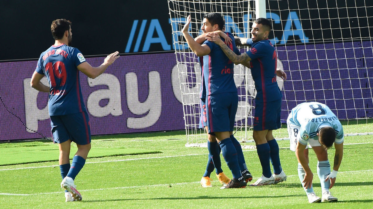 Atletico Madrid's Uruguayan forward Luis Suarez celebrates with teammates after scoring a goal during the Spanish League football match between Celta Vigo and Atletico Madrid at the Balaidos stadium in Vigo on October 17, 2020.