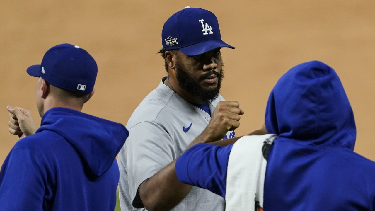 ARLINGTON, TX - OCTOBER 16: Kenley Jansen #74 of the Los Angeles Dodgers high fives teammates after beating the Atlanta Braves in Game 5 of the NLCS at Globe Life Field on Friday, October 16, 2020 in Arlington, Texas.
