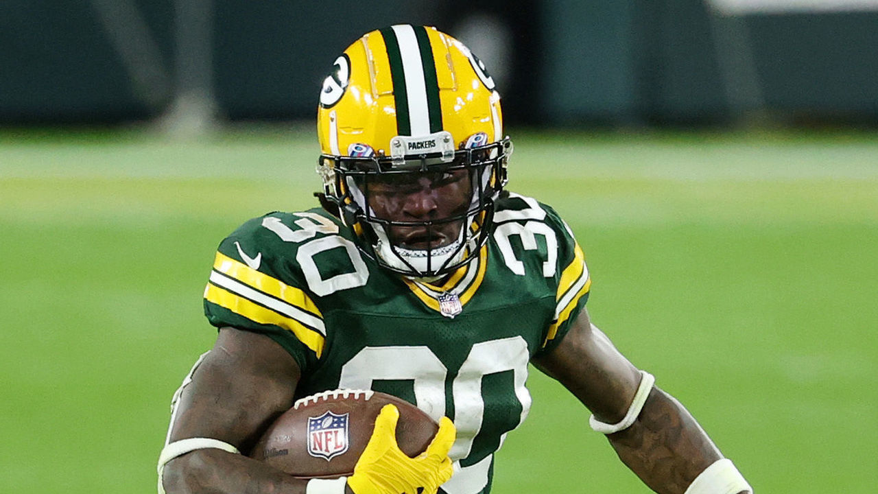 GREEN BAY, WISCONSIN - OCTOBER 05: Jamaal Williams #30 of the Green Bay Packers runs with the ball during the first half against the Atlanta Falcons at Lambeau Field on October 05, 2020 in Green Bay, Wisconsin.