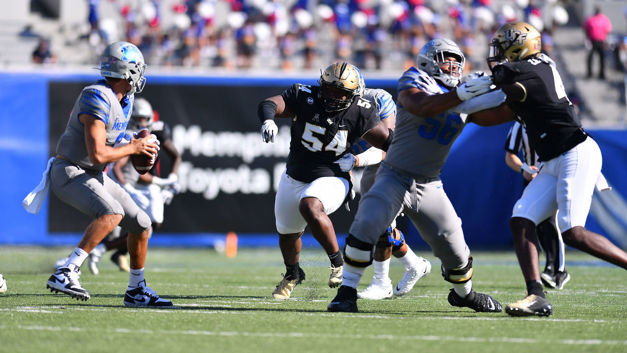 MEMPHIS, TN - OCTOBER 17: Cam Goode #54 of the UCF Knights rushes the Memphis Tigers quarterback in the first half at Liberty Bowl Memorial Stadium on October 17, 2020 in Memphis, Tennessee.