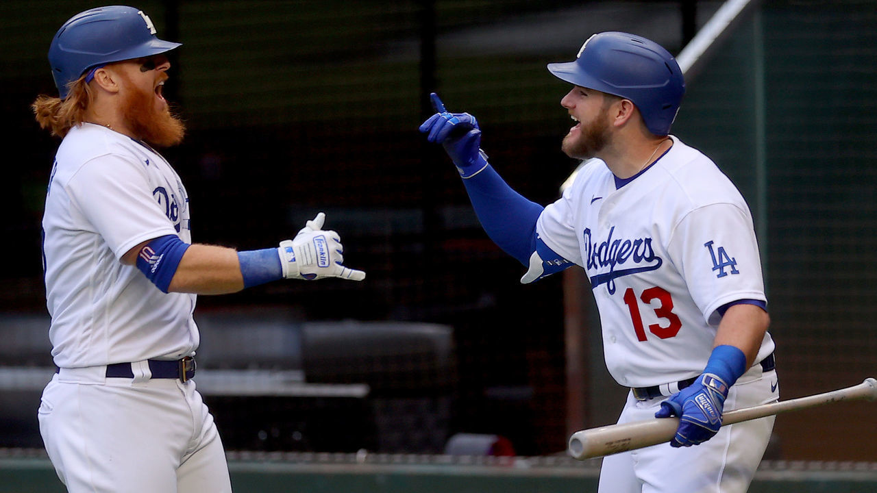 ARLINGTON, TEXAS - OCTOBER 17: Justin Turner #10 of the Los Angeles Dodgers is congratulated by Max Muncy #13 after hitting a solo home run against the Atlanta Braves during the first inning in Game Six of the National League Championship Series at Globe Life Field on October 17, 2020 in Arlington, Texas.