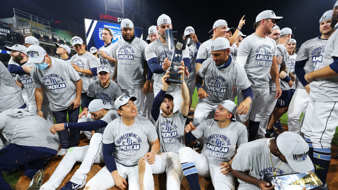 SAN DIEGO, CA - OCTOBER 17: Members of the Tampa Bay Rays celebrate with the 2020 American League Champions trophy after they win Game 7 of the ALCS 4-2 against the Houston Astros at Petco Park on Saturday, October 17, 2020 in San Diego, California.