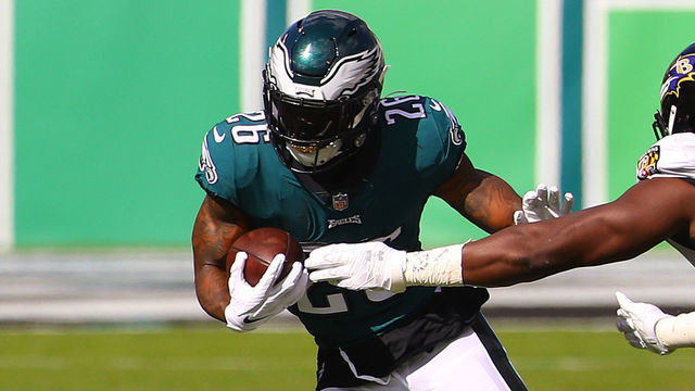 PHILADELPHIA, PENNSYLVANIA - OCTOBER 18: Miles Sanders #26 of the Philadelphia Eagles runs for a four yard gain against Pernell McPhee #90 of the Baltimore Ravens during the first quarter at Lincoln Financial Field on October 18, 2020 in Philadelphia, Pennsylvania.