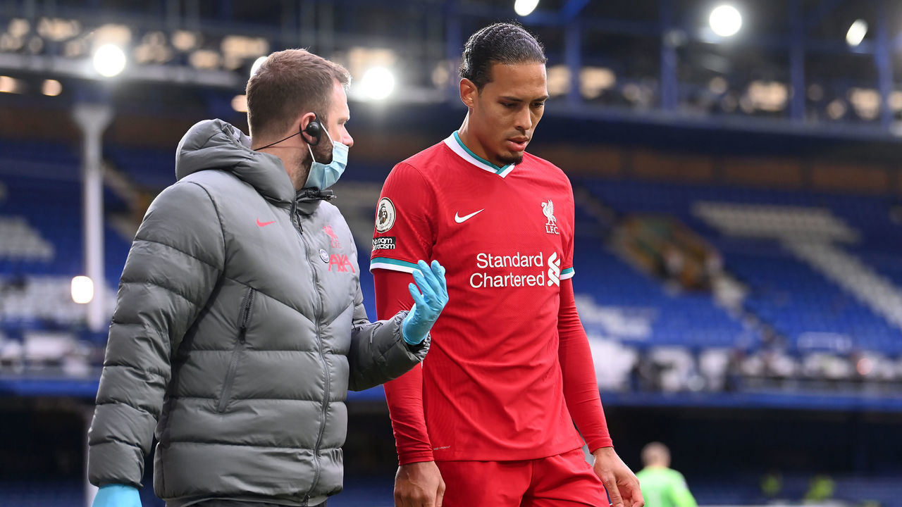 Liverpool's Virgil van Dijk leaves the game with an injury after a challenge by Everton goalkeeper Jordan Pickford during the Premier League match at Goodison Park, Liverpool.