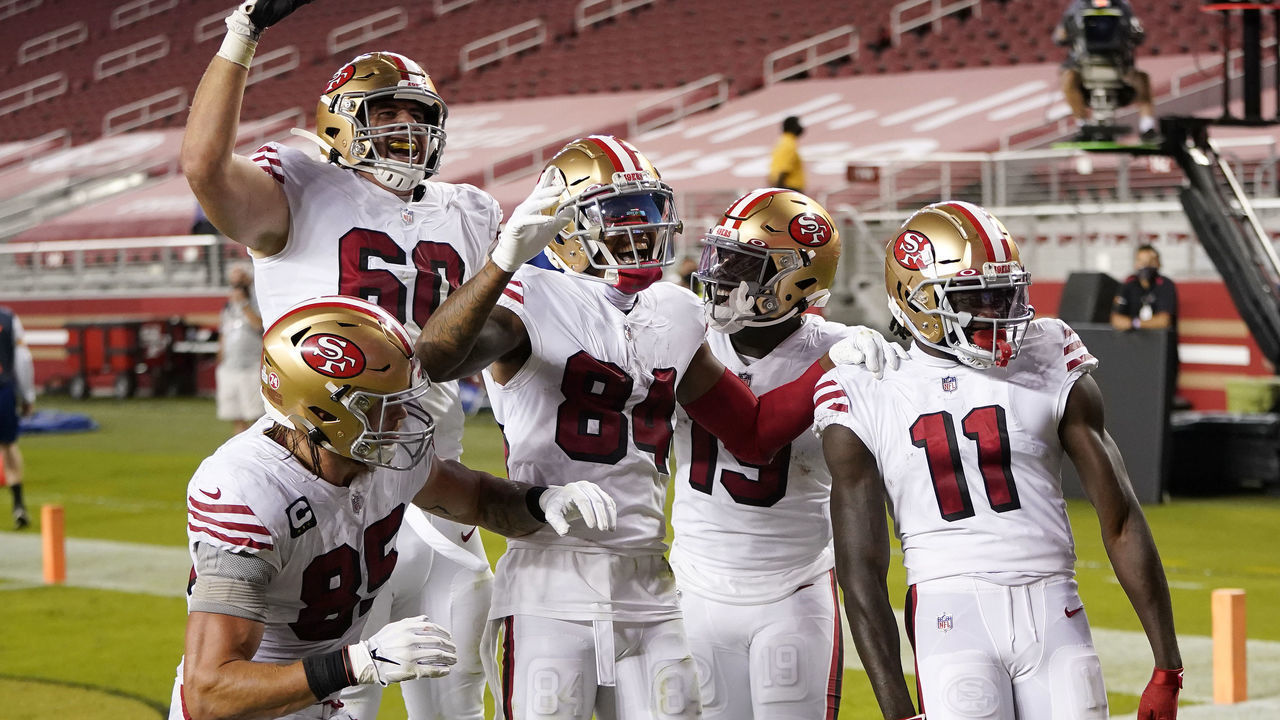 SANTA CLARA, CALIFORNIA - OCTOBER 18: Teammates celebrate with Brandon Aiyuk #11 of the San Francisco 49ers after Aiyuk scored a touchdown against the Los Angeles Rams during the second quarter at Levi's Stadium on October 18, 2020 in Santa Clara, California.