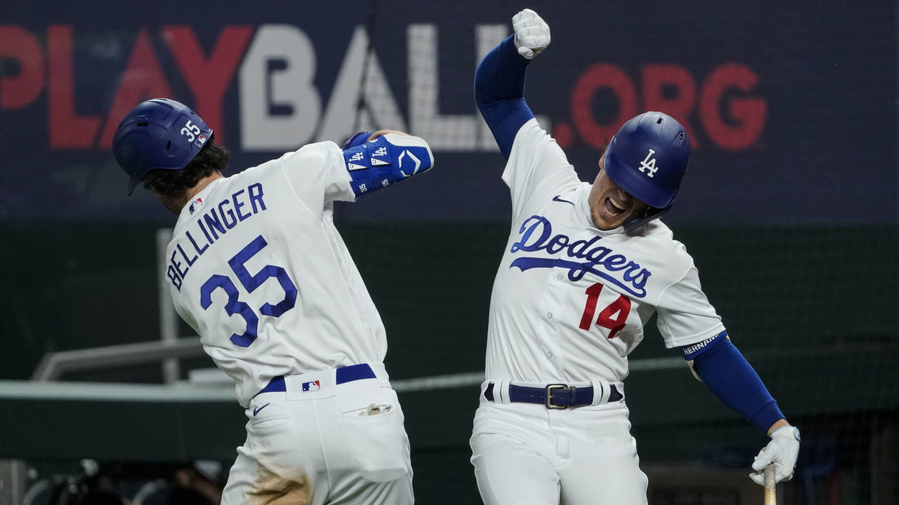 ARLINGTON, TX - OCTOBER 18: Cody Bellinger #35 of the Los Angeles Dodgers high fives Enrique Hernandez #14 after hitting a solo home run in the seventh inning during Game 7 of the NLCS between the Atlanta Braves and the Los Angeles Dodgers at Globe Life Field on Sunday, October 18, 2020 in Arlington, Texas.