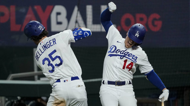 ARLINGTON, TX - OCTOBER 18: Cody Bellinger #35 of the Los Angeles Dodgers high fives Enrique Hernandez #14 after hitting a solo home run in the seventh inning during Game 7 of the NLCS between the Atlanta Braves and the Los Angeles Dodgers at Globe Life Field on Sunday, October 18, 2020 in Arlington, Texas.