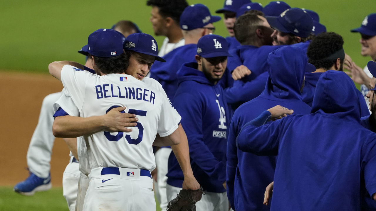 ARLINGTON, TX - OCTOBER 18: Cody Bellinger #35 of the Los Angeles Dodgers hugs Corey Seager #5 after beating the Atlanta Braves in Game 7 of the NLCS to clinch a World Series berth at Globe Life Field on Sunday, October 18, 2020 in Arlington, Texas.