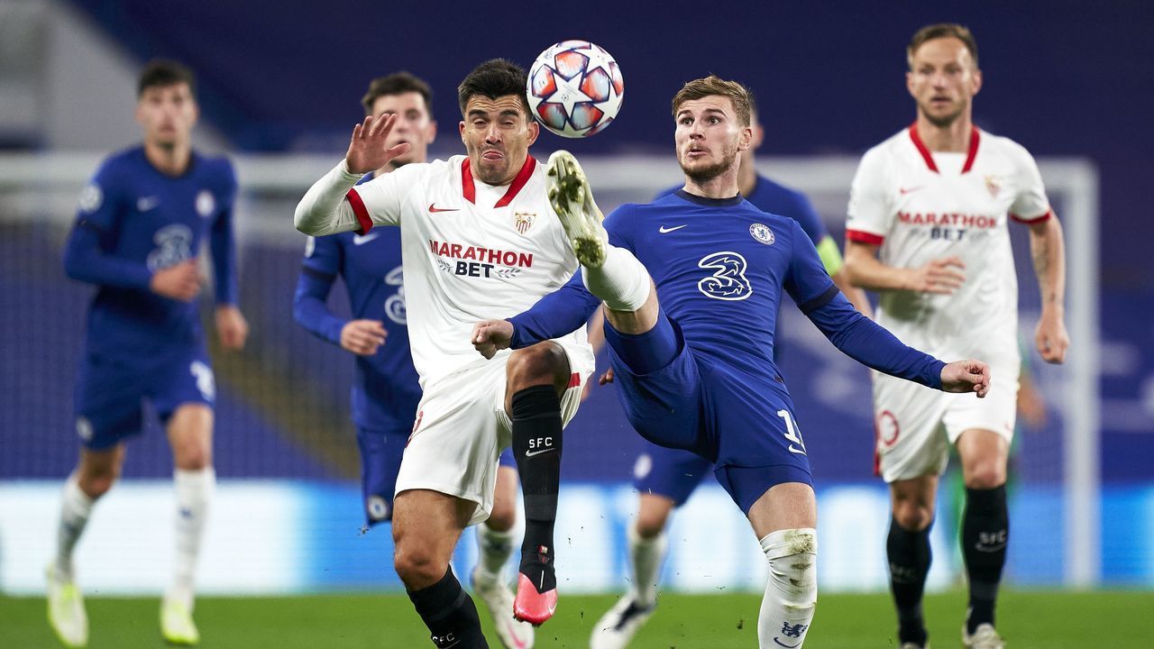 LONDON, ENGLAND - OCTOBER 20: Timo Werner of Chelsea competes for the ball with Marcos Acuña of Sevilla during the UEFA Champions League Group E stage match between Chelsea FC and FC Sevilla at Stamford Bridge on October 20, 2020 in London, England.Sporting stadiums around the UK remain under strict restrictions due to the Coronavirus Pandemic as Government social distancing laws prohibit fans inside venues resulting in games being played behind closed doors.