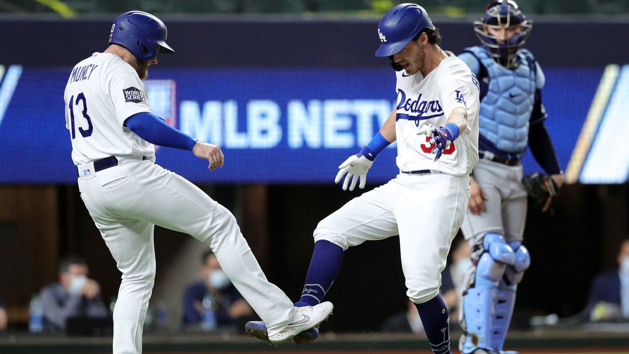 ARLINGTON, TX - OCTOBER 20: Cody Bellinger #35 of the Los Angeles Dodgers celebrates with Max Muncy #13 after hitting a two-run home run in the fourth inning during Game 1 of the 2020 World Series between the Los Angeles Dodgers and the Tampa Bay Rays at Globe Life Field on Tuesday, October 20, 2020 in Arlington, Texas.