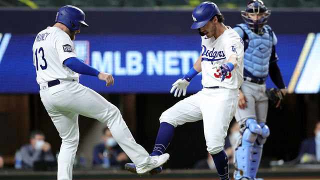 ARLINGTON, TX - OCTOBER 20: Cody Bellinger #35 of the Los Angeles Dodgers celebrates with Max Muncy #13 after hitting a two-run home run in the fourth inning during Game 1 of the 2020 World Series between the Los Angeles Dodgers and the Tampa Bay Rays at Globe Life Field on Tuesday, October 20, 2020 in Arlington, Texas.