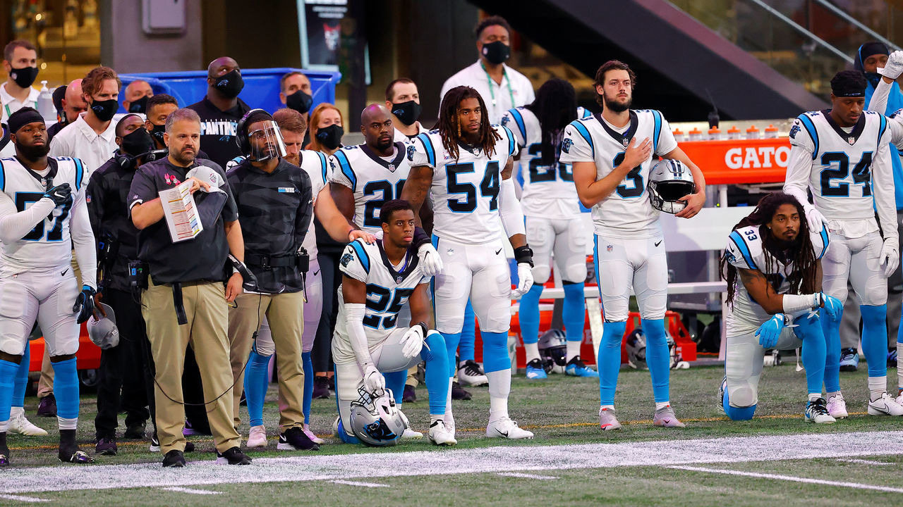 ATLANTA, GEORGIA - OCTOBER 11: Troy Pride Jr. #25 and Tre Boston #33 of the Carolina Panthers kneel alongside their teammates and head coach Matt Rhule during the National Anthem prior to facing the Atlanta Falcons at Mercedes-Benz Stadium on October 11, 2020 in Atlanta, Georgia.