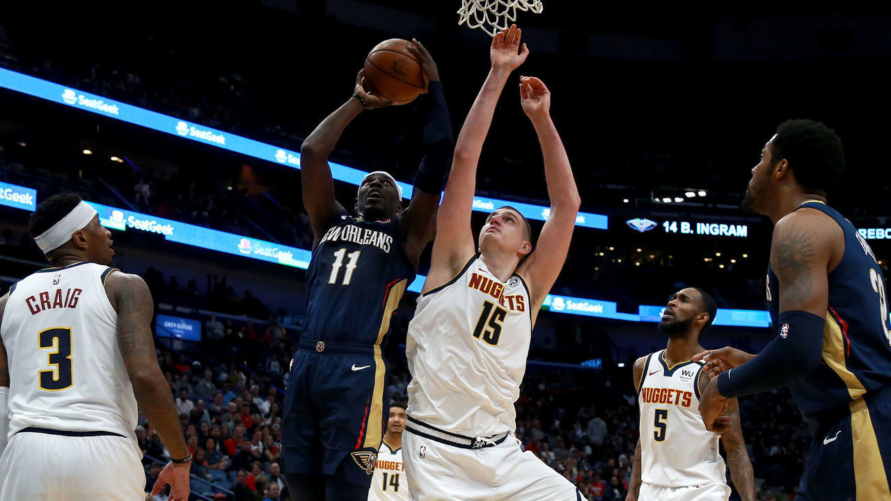 NEW ORLEANS, LOUISIANA - JANUARY 24: Jrue Holiday #11 of the New Orleans Pelicans shoots over Nikola Jokic #15 of the Denver Nuggets during a NBA game at Smoothie King Center on January 24, 2020 in New Orleans, Louisiana.