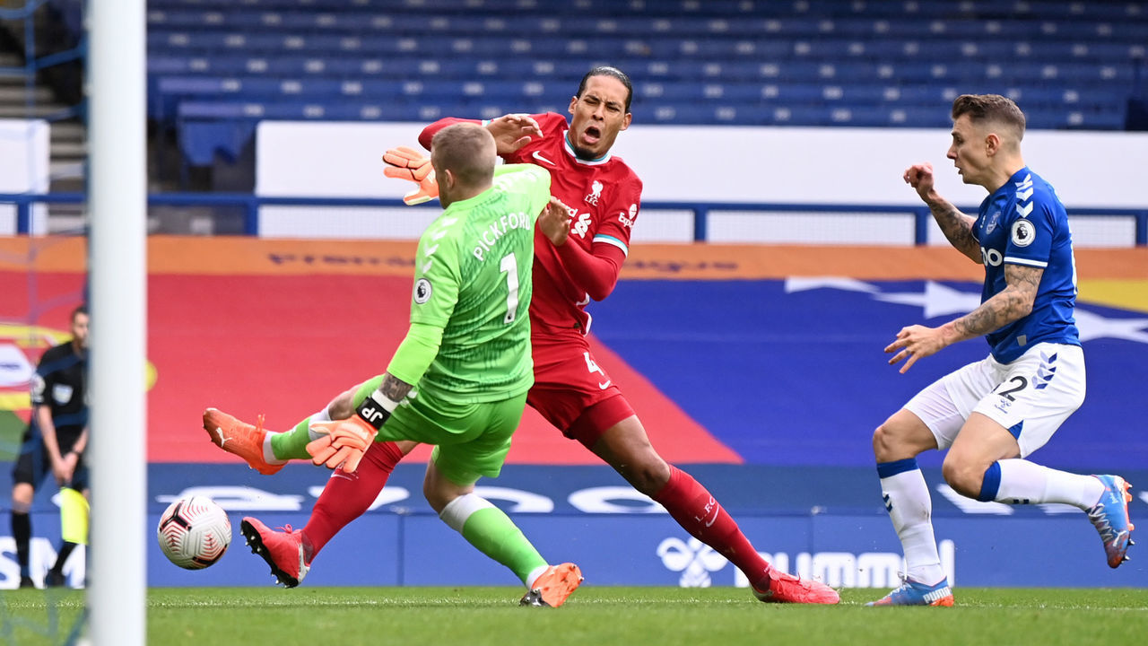 LIVERPOOL, ENGLAND - OCTOBER 17: Virgil van Dijk of Liverpool is tackled by Jordan Pickford of Everton which led to Virgil van Dijk being substituted for an injury during the Premier League match between Everton and Liverpool at Goodison Park on October 17, 2020 in Liverpool, England. Sporting stadiums around the UK remain under strict restrictions due to the Coronavirus Pandemic as Government social distancing laws prohibit fans inside venues resulting in games being played behind closed doors.