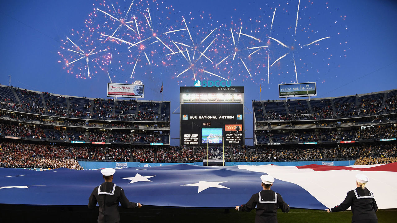 SAN DIEGO, CA - DECEMBER 27: Fireworks in the sky over SDCCU Stadium and a large US Flag on the field before the start of the 2019 Holiday Bowl played on December 27, 2019 between the USC Trojans and the Iowa Hawkeyes at SDCCU Stadium in San Diego, CA.