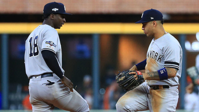 HOUSTON, TEXAS - OCTOBER 12: Didi Gregorius #18 and Gleyber Torres #25 of the New York Yankees celebrate their teams 7-0 win over the Houston Astros in game one of the American League Championship Series at Minute Maid Park on October 12, 2019 in Houston, Texas.