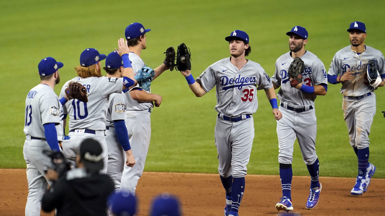 ARLINGTON, TX - OCTOBER 23: Max Muncy #13, Justin Turner #10, Corey Seager #5, Cody Bellinger #35, Chris Taylor #3 and Mookie Betts #50 of the Los Angeles Dodgers celebrate after winning Game 3 of the 2020 World Series between the Los Angeles Dodgers and the Tampa Bay Rays at Globe Life Field on Friday, October 23, 2020 in Arlington, Texas.