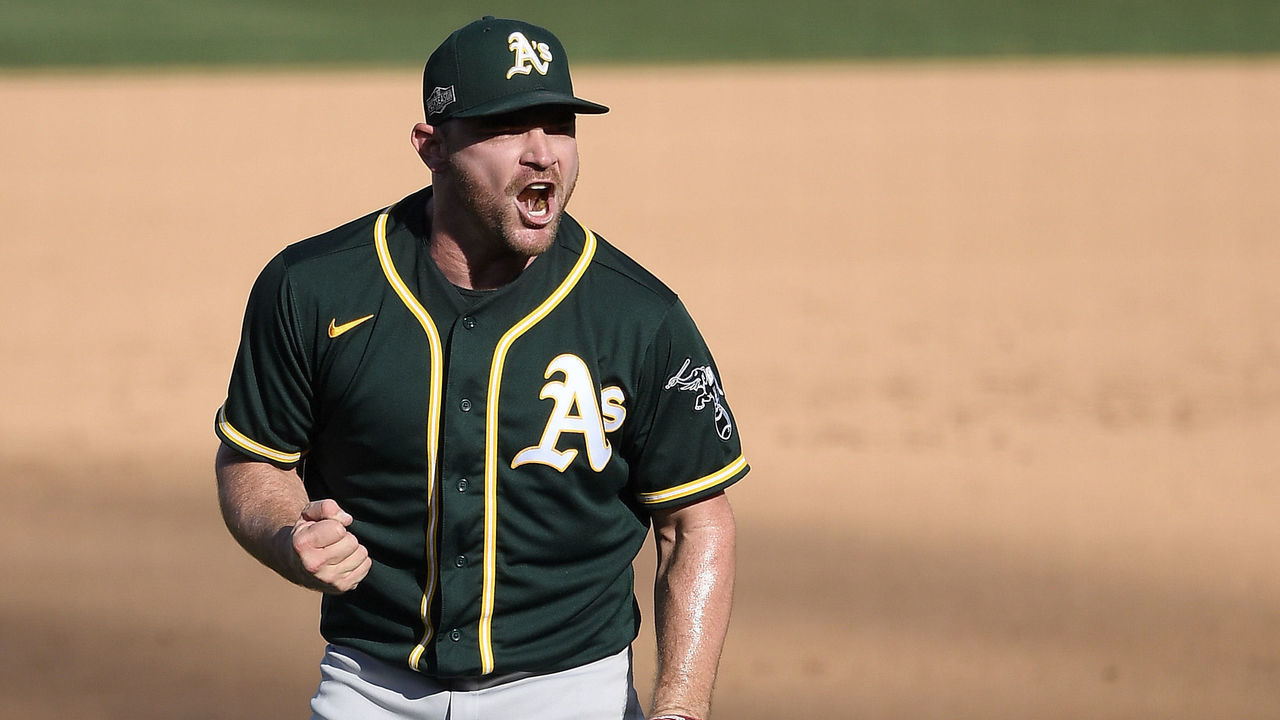 LOS ANGELES, CALIFORNIA - OCTOBER 07: Liam Hendriks #16 of the Oakland Athletics celebrates a 9-7 win against the Houston Astros in Game Three of the American League Division Series at Dodger Stadium on October 07, 2020 in Los Angeles, California.