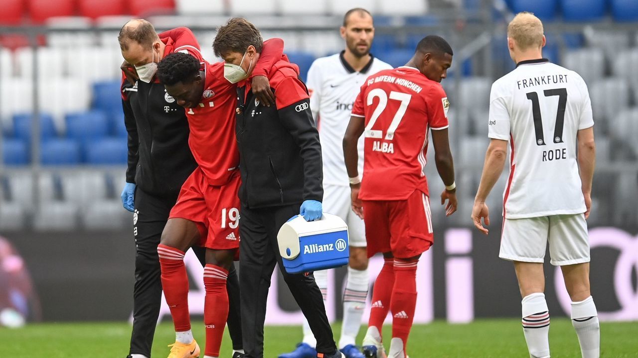 Bayern Munich's Canadian midfielder Alphonso Davies is helped off injured at the start of the German first division Bundesliga football match between FC Bayern Munich and Eintracht Frankfurt on October 24, 2020 in Munich, southern Germany.
