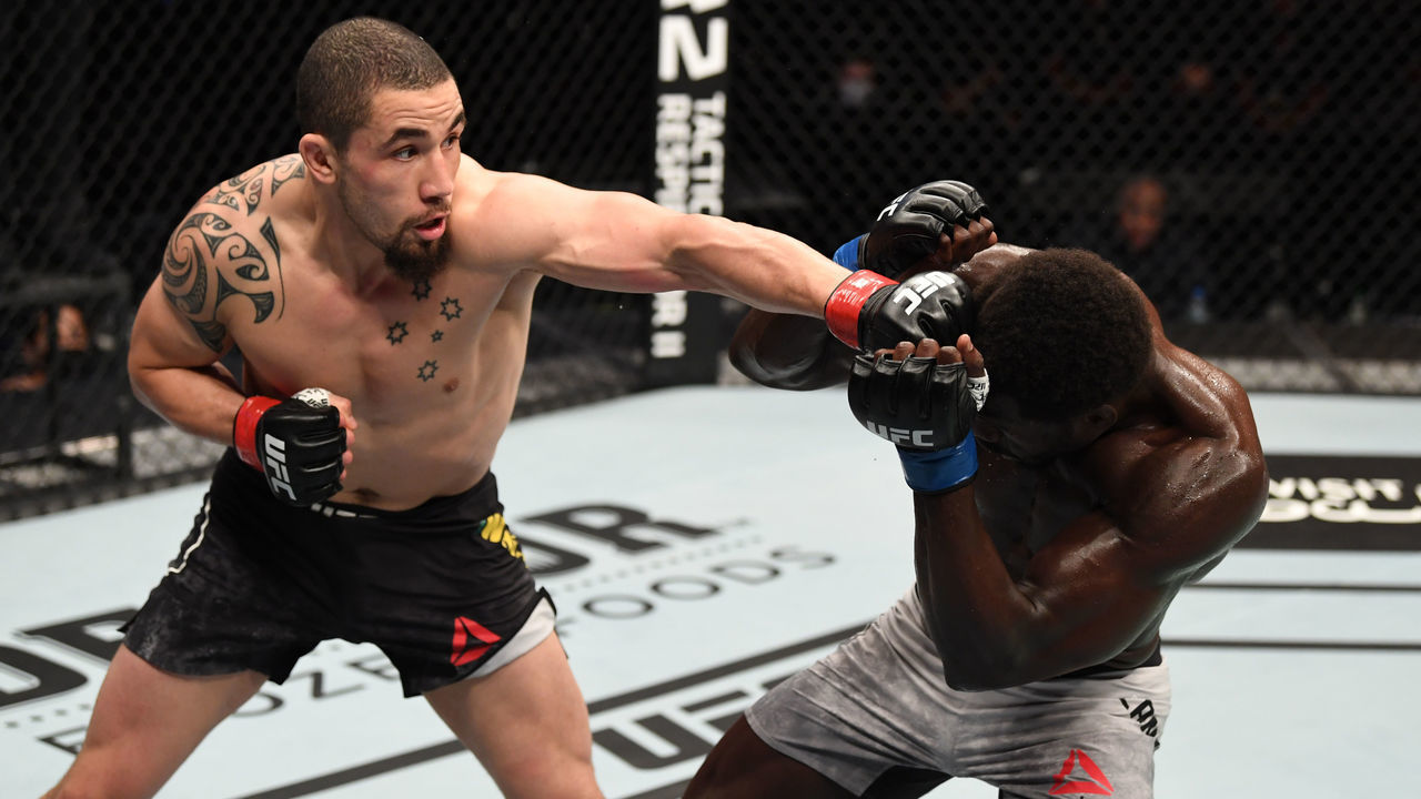 ABU DHABI, UNITED ARAB EMIRATES - OCTOBER 25: (L-R) Robert Whittaker of Australia punches Jared Cannonier in their middleweight bout during the UFC 254 event on October 25, 2020 on UFC Fight Island, Abu Dhabi, United Arab Emirates.