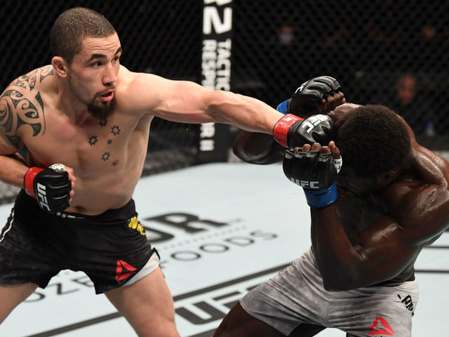 ABU DHABI, UNITED ARAB EMIRATES - OCTOBER 25: (L-R) Robert Whittaker of Australia punches Jared Cannonier in their middleweight bout during the UFC 254 event on October 25, 2020 on UFC Fight Island, Abu Dhabi, United Arab Emirates.