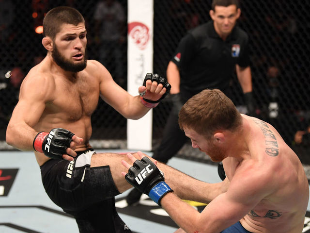 ABU DHABI, UNITED ARAB EMIRATES - OCTOBER 25: (L-R) Khabib Nurmagomedov of Russia kicks Justin Gaethje in their lightweight title bout during the UFC 254 event on October 25, 2020 on UFC Fight Island, Abu Dhabi, United Arab Emirates.
