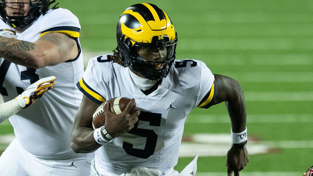 MINNEAPOLIS, MINNESOTA - OCTOBER 24: Joe Milton #5 of the Michigan Wolverines carries the ball against the Minnesota Golden Gophers in the second quarter of the game at TCF Bank Stadium on October 24, 2020 in Minneapolis, Minnesota.