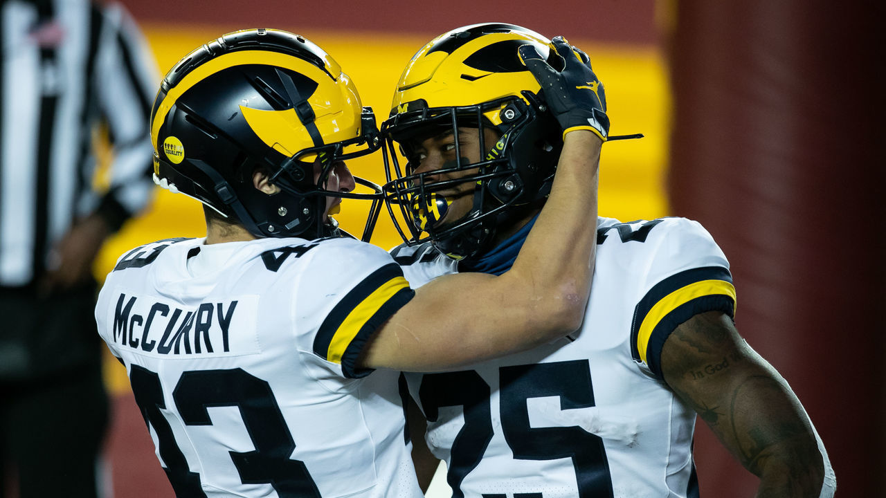 MINNEAPOLIS, MINNESOTA - OCTOBER 24: Hassan Haskins #25 of the Michigan Wolverines celebrates with Jake McCurry #43 after scoring a touchdown against the Minnesota Golden Gophers in the second quarter of the game at TCF Bank Stadium on October 24, 2020 in Minneapolis, Minnesota.