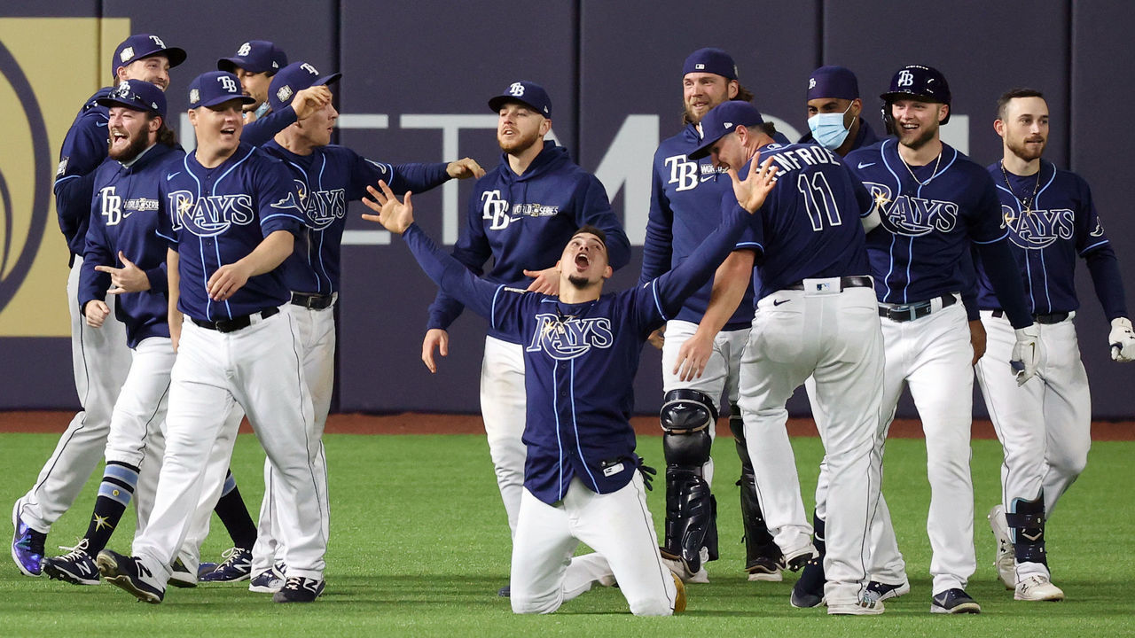 ARLINGTON, TEXAS - OCTOBER 24: The Tampa Bay Rays celebrate the ninth inning two-run walk-off single by Brett Phillips #14 to defeat the Los Angeles Dodgers 8-7 in Game Four of the 2020 MLB World Series at Globe Life Field on October 24, 2020 in Arlington, Texas.