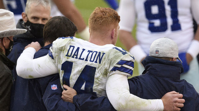 LANDOVER, MARYLAND - OCTOBER 25: Quarterback Andy Dalton #14 of the Dallas Cowboys is helped off the field after being hit and injured by Jon Bostic #53 (not pictured) of the Washington Football Team in the third quarter of the game at FedExField on October 25, 2020 in Landover, Maryland.