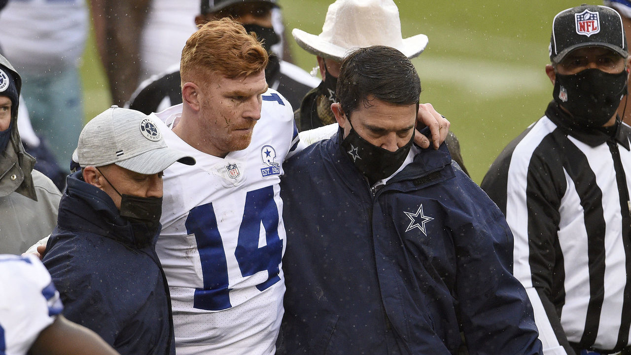 LANDOVER, MARYLAND - OCTOBER 25: Quarterback Andy Dalton #14 of the Dallas Cowboys is helped off the field after being hit and injured by Jon Bostic #53 (not pictured) of the Washington Football Team in the third quarter of the game at FedExField on October 25, 2020 in Landover, Maryland.