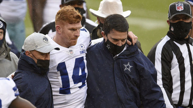 LANDOVER, MARYLAND - OCTOBER 25: Quarterback Andy Dalton #14 of the Dallas Cowboys is helped off the field after being hit and injured by Jon Bostic #53 (not pictured) of the Washington Football Team in the third quarter of the game at FedExField on October 25, 2020 in Landover, Maryland.